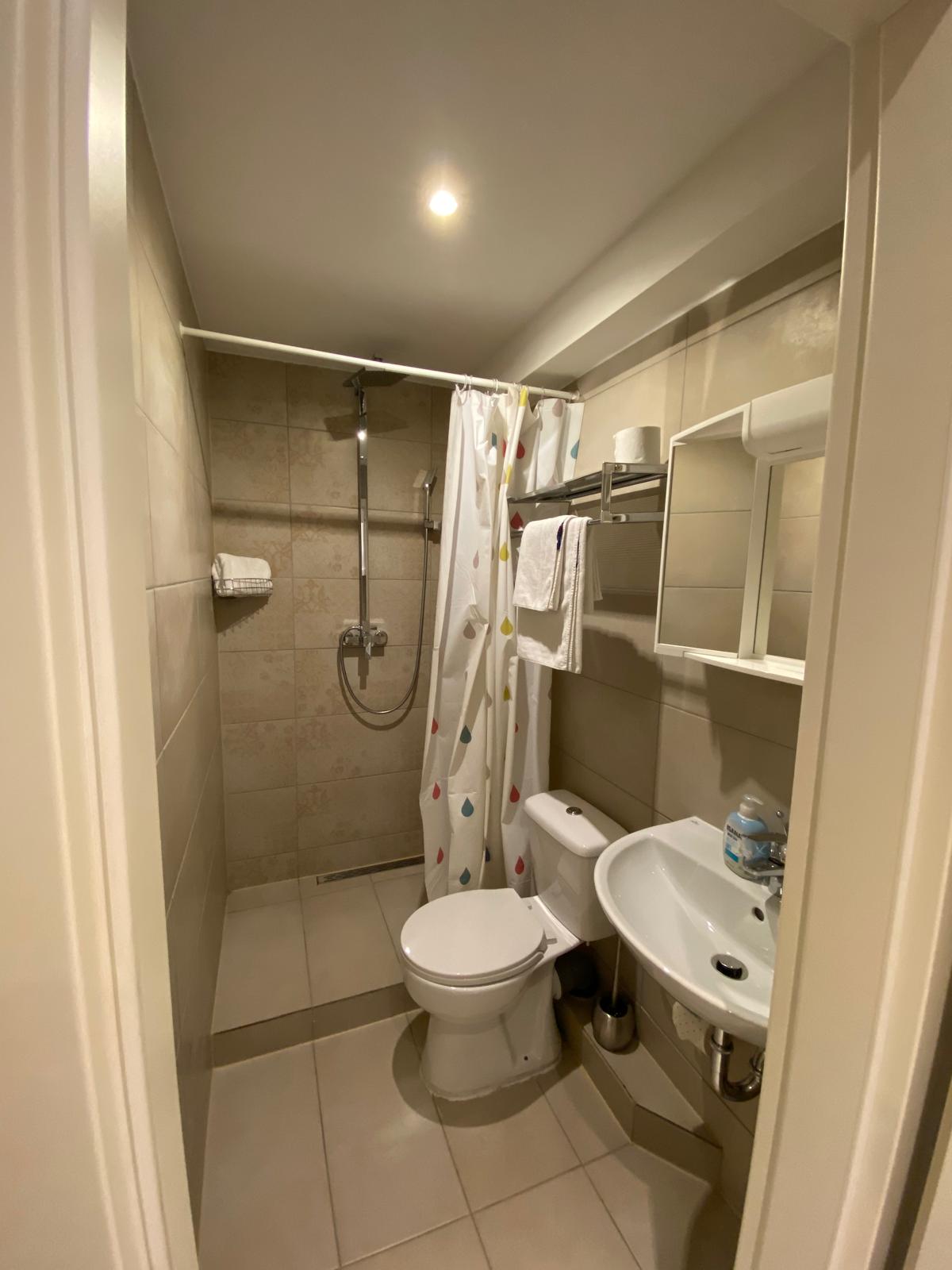 Bathroom with shower, toilet and sink at Hotel Weller Dietzenbach