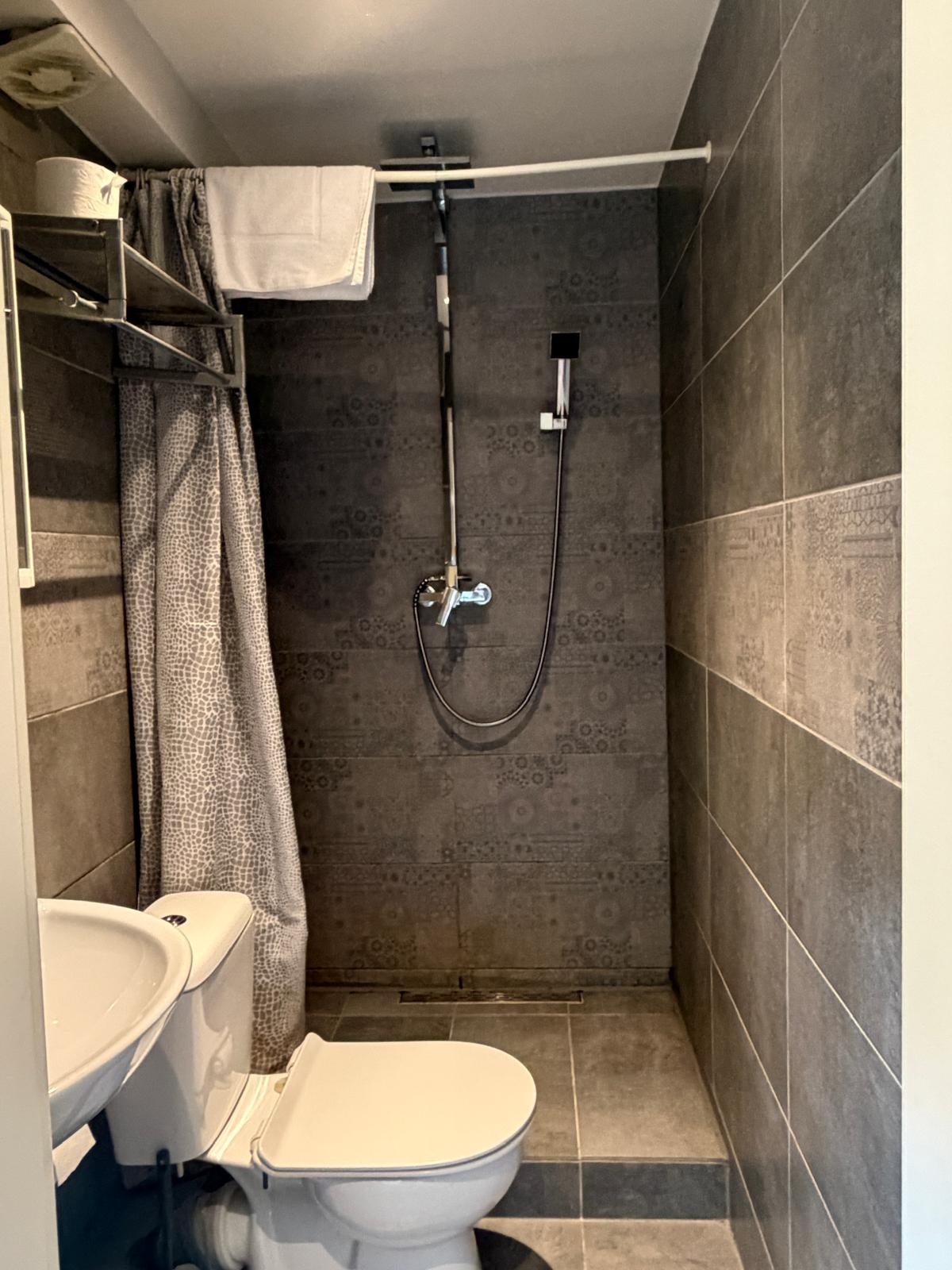 Tiled bathroom with shower at Hotel Weller Dietzenbach