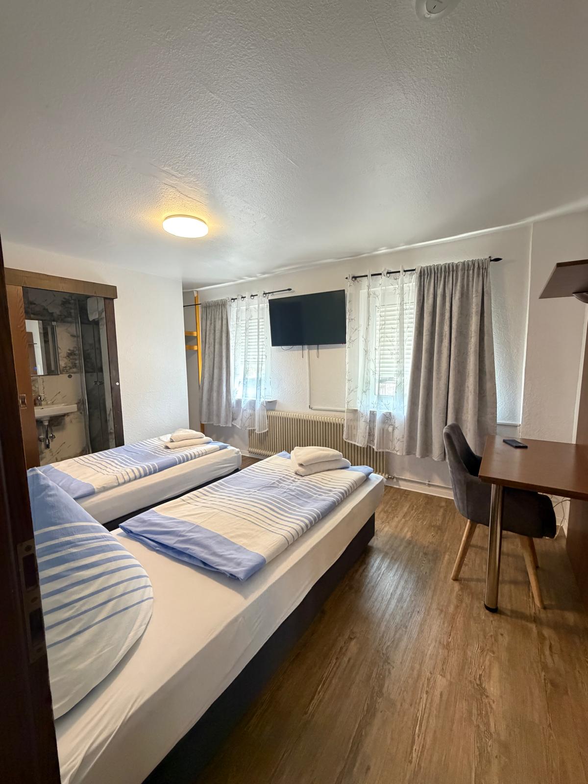 Room with three single beds, TV and private bath at Hotel Weller Dietzenbach